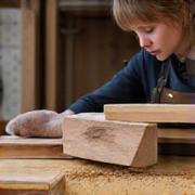 Skilled Woodworker Aoife Brennan polishing a finely crafted wooden vanity drawer